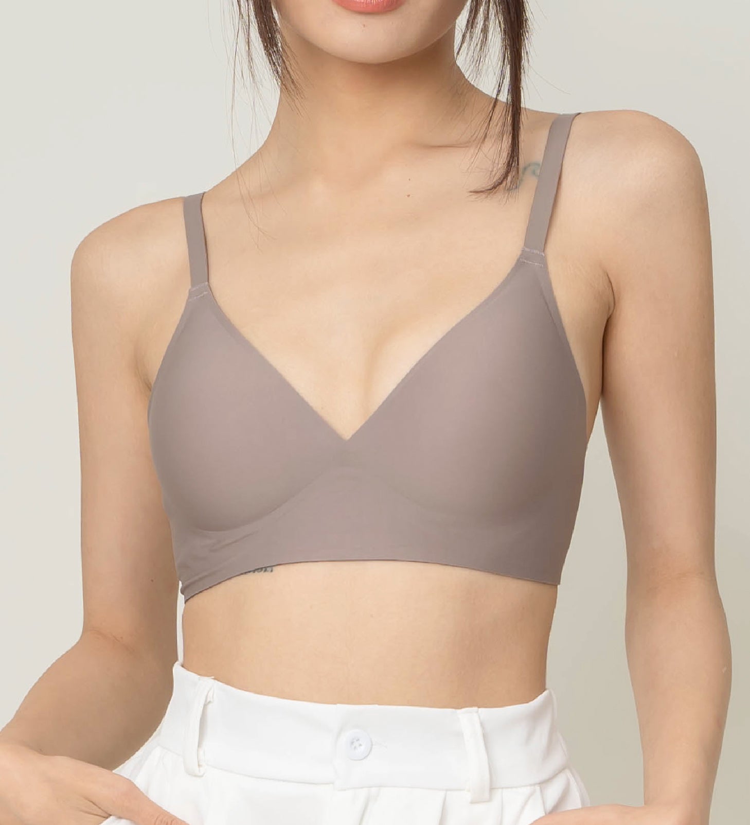 Chantelle's Secret Tri-Cup Daily Seamless Bra in a versatile taupe shade, featuring a soft v-neckline and slender straps for everyday elegance.