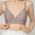 Chantelle's Secret Tri-Cup Daily Seamless Bra in taupe, demonstrating its sleek V-neck design for a smooth silhouette under clothing.