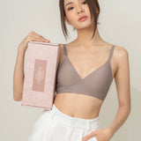 Elegant presentation of Chantelle's Secret Tri-Cup Daily Seamless Bra in a sophisticated taupe, held next to its branded box, ready for the perfect unboxing experience.